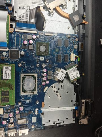 Laptop motherboard with fresh thermal paste applied to the processor