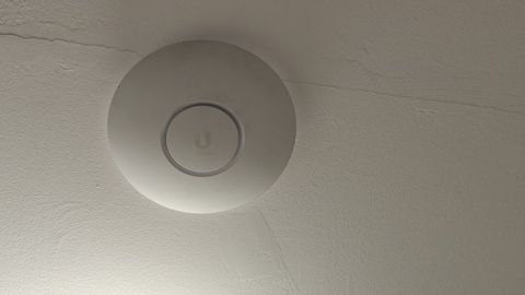 Ceiling-mounted Wi-Fi access point installed by COMPwize